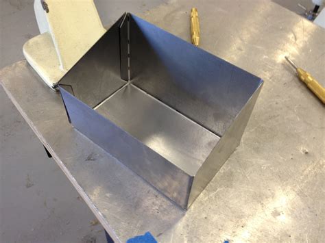 a metal worker is making a box|how to make sheet metal boxes.